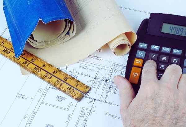 a calculator, ruler and floor plans